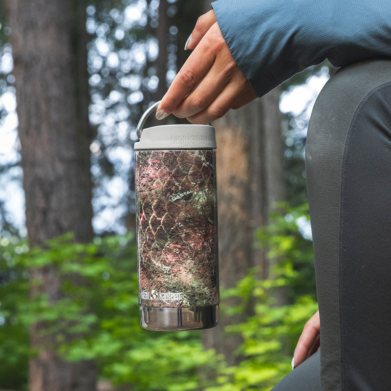 12oz-tkwide-with-cafe-cap-mossy-oak-l6 12oz_tumbler_mossyoak_rainbowtrout_hand_closeup_square.jpg