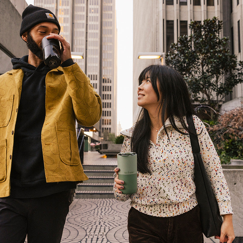16oz-rise-tumbler-c8 16oz_rise_tumbler_black_iceberg_couple_drink_city_street_square.jpg