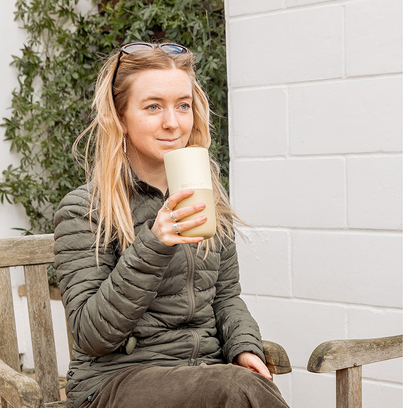 16oz-rise-tumbler-c8 16oz_rise_tumbler_wax_yellow_woman_seat_outside_square.jpg